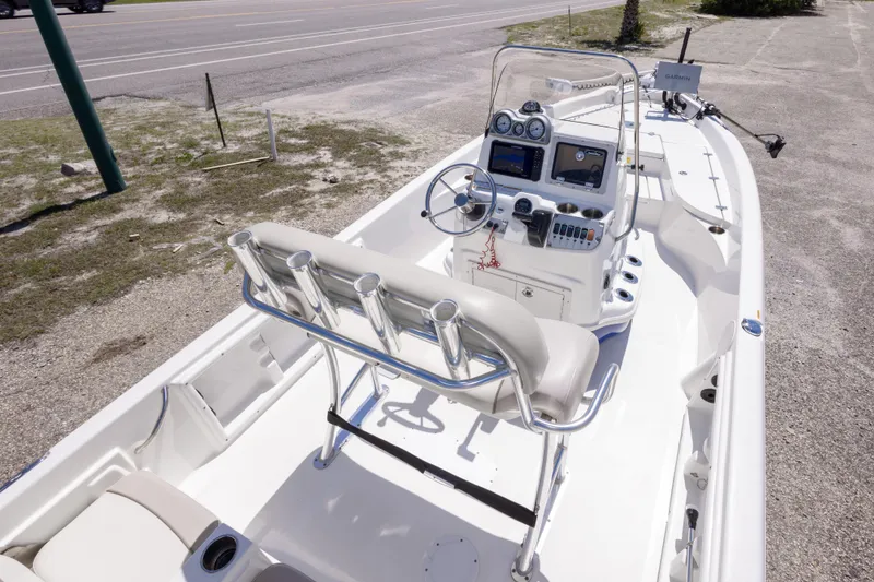 Slide: The Image of 2015 NauticStar 214 XTS boat with modern console and seating, parked on a gravel lot. - 27