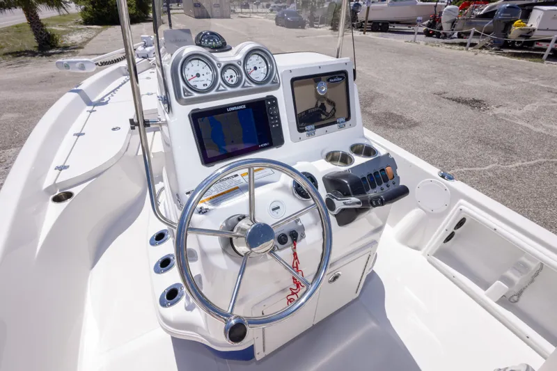 Slide: The Image of 2015 NauticStar 214 XTS boat dashboard with steering wheel and navigation displays. - 30