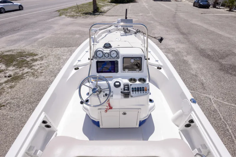 Slide: The Image of 2015 NauticStar 214 XTS boat dashboard with steering wheel and navigation controls. - 32