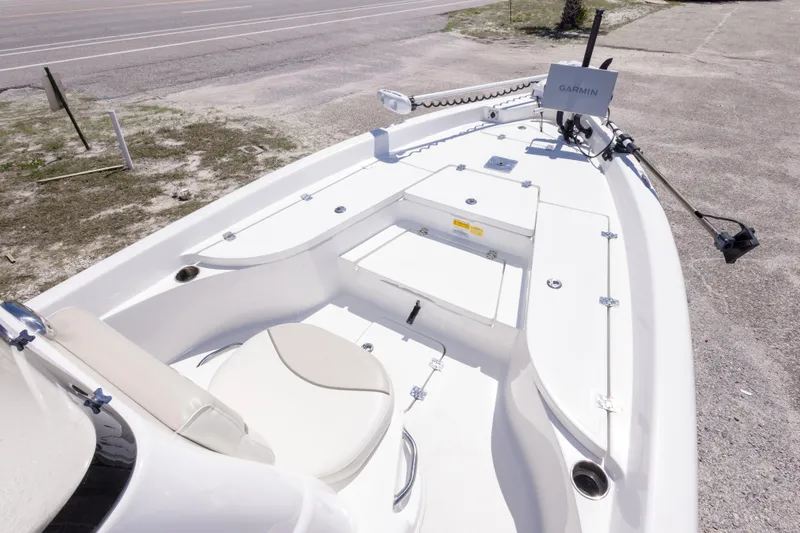 Slide: The Image of 2015 NauticStar 214 XTS boat interior with Garmin equipment, parked on a sandy area. - 34