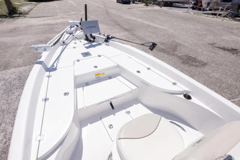 Slide: The Image of 2015 NauticStar 214 XTS boat with Garmin equipment, parked on a concrete surface. - 35