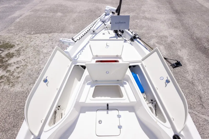 Slide: The Image of 2015 NauticStar 214 XTS boat deck with open storage compartments and Garmin equipment. - 38