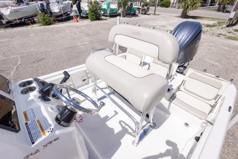 Slide: The Image of 2015 NauticStar 214 XTS boat interior with steering wheel and seating. - 44