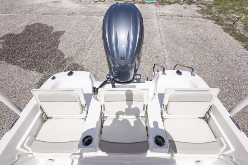 Slide: The Image of 2015 NauticStar 214 XTS boat with three white seats and an outboard motor. - 48