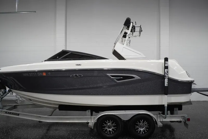 The Image of 2018 Sea Ray SLX-W 230 boat on trailer in indoor showroom. - 0