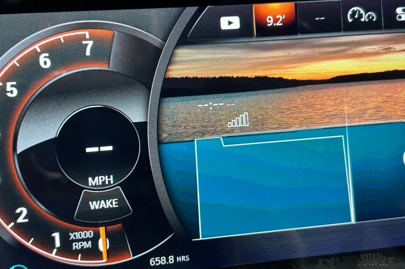 Slide: The Image of Dashboard of 2018 Sea Ray SLX-W 230 boat with speedometer and lake view. - 12