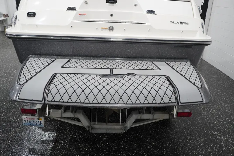 Slide: The Image of 2018 Sea Ray SLX-W 230 boat rear view with patterned swim platform. - 14
