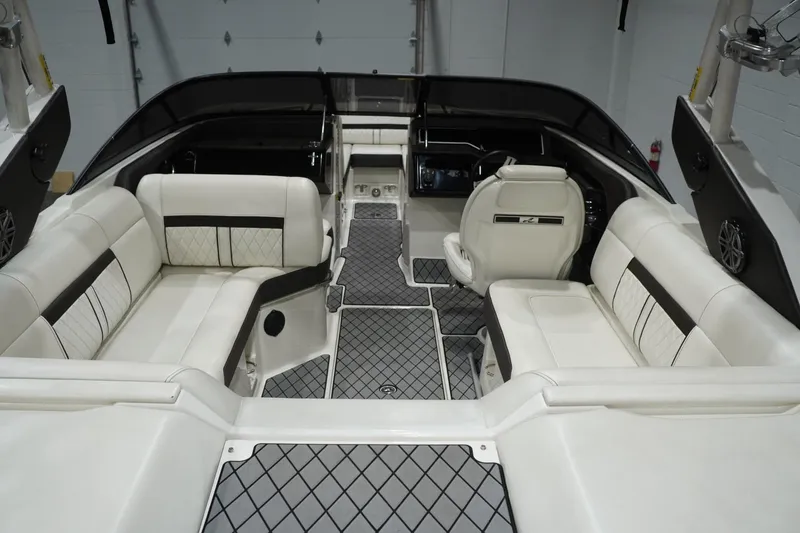 Slide: The Image of 2018 Sea Ray SLX-W 230 boat interior with luxurious white seating and modern design. - 17