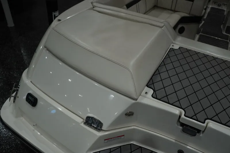 Slide: The Image of 2018 Sea Ray SLX-W 230 boat interior with cushioned seating and non-slip flooring. - 18