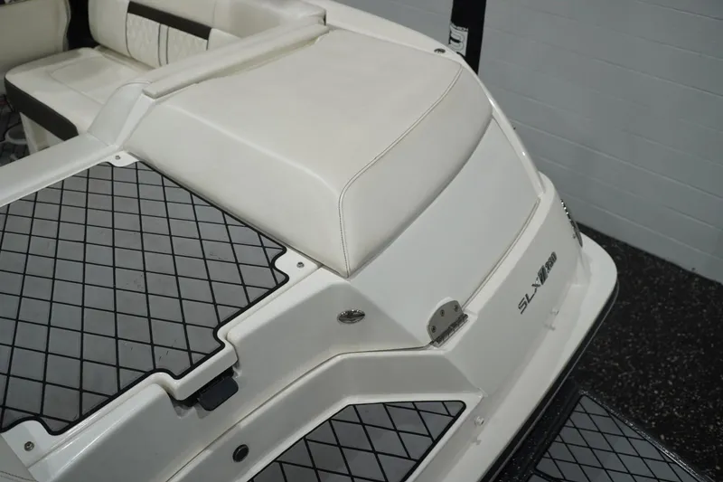 Slide: The Image of 2018 Sea Ray SLX-W 230 boat interior with cushioned seating and non-slip flooring. - 19