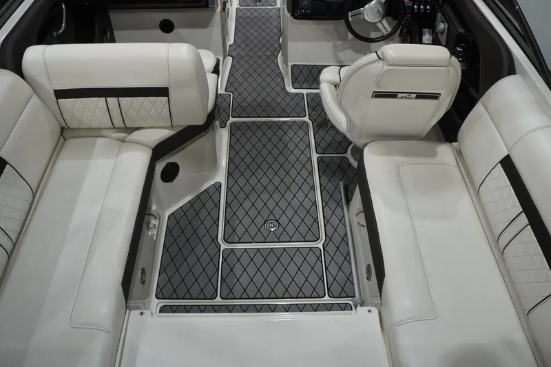 Slide: The Image of 2018 Sea Ray SLX-W 230 interior with luxurious white seating and diamond-patterned flooring. - 21