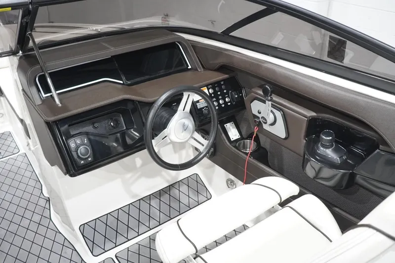Slide: The Image of 2018 Sea Ray SLX-W 230 boat interior with steering wheel and control panel. - 24