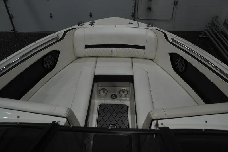 Slide: The Image of 2018 Sea Ray SLX-W 230 boat interior with white cushioned seating and cup holders. - 26