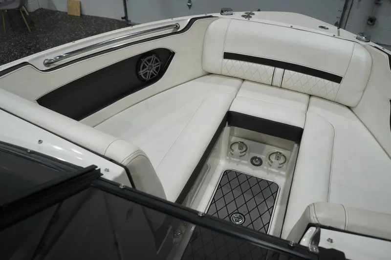 Slide: The Image of 2018 Sea Ray SLX-W 230 boat interior with white cushioned seating and speaker detail. - 27