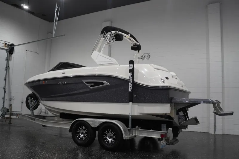 Slide: The Image of 2018 Sea Ray SLX-W 230 boat on trailer in indoor showroom. - 3