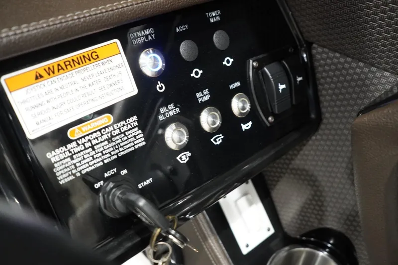 Slide: The Image of Control panel of a 2018 Sea Ray SLX-W 230 boat with warning labels and switches. - 31