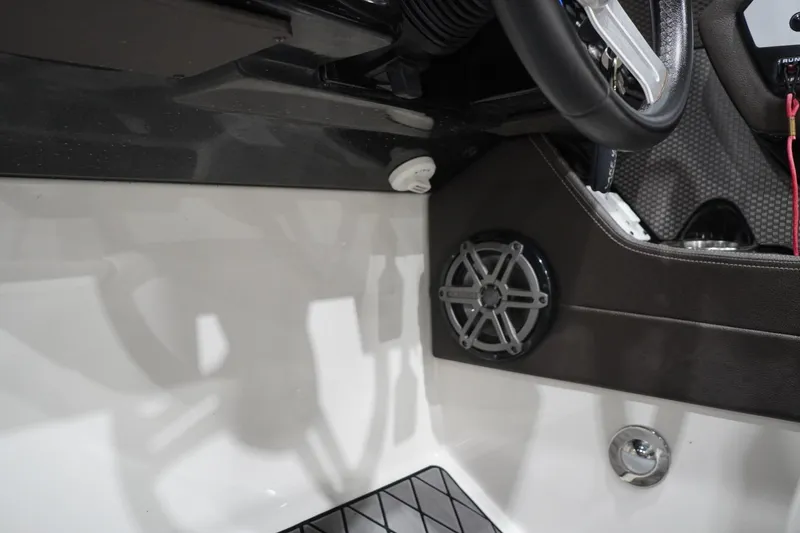 Slide: The Image of Interior view of 2018 Sea Ray SLX-W 230 boat dashboard with speaker and steering wheel. - 33