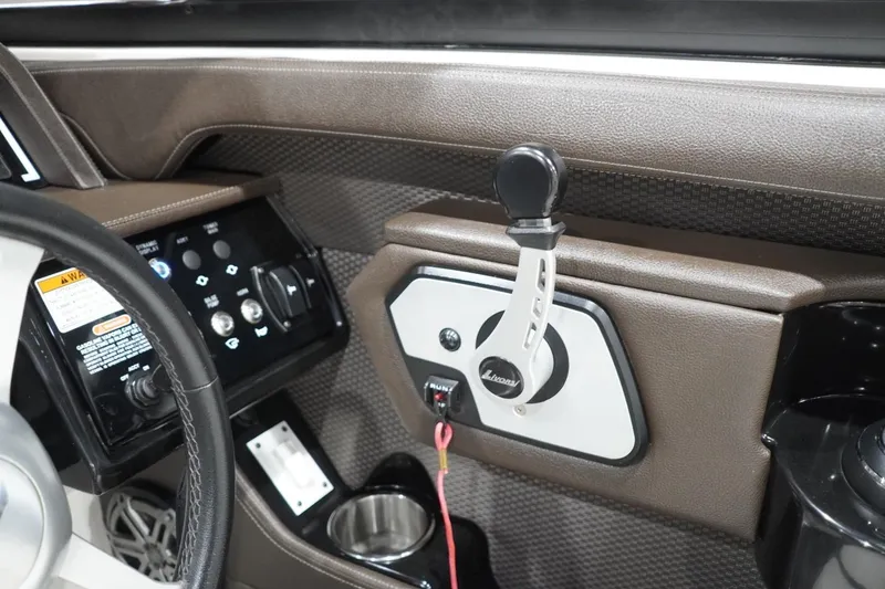 Slide: The Image of 2018 Sea Ray SLX-W 230 boat dashboard with steering wheel and control panel. - 34