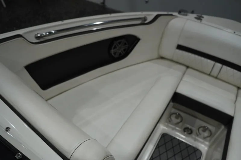 Slide: The Image of 2018 Sea Ray SLX-W 230 boat interior with white cushioned seating and speaker. - 39