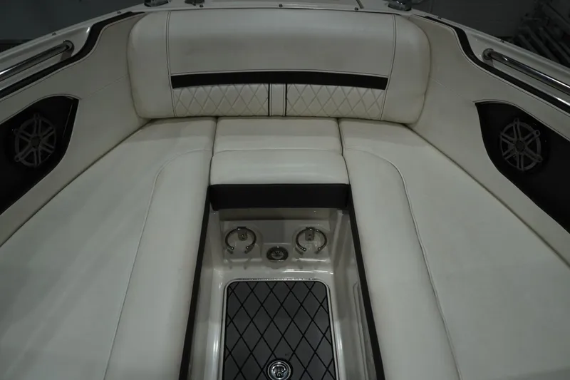 Slide: The Image of 2018 Sea Ray SLX-W 230 boat interior with white cushioned seating and speaker system. - 40