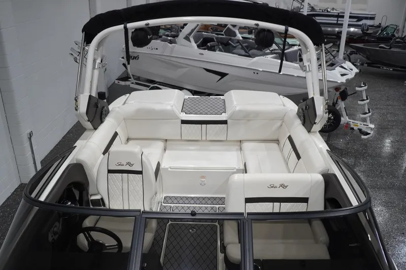 Slide: The Image of 2018 Sea Ray SLX-W 230 boat interior with white seating and sleek design. - 42