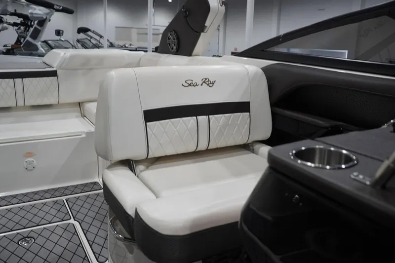 Slide: The Image of 2018 Sea Ray SLX-W 230 boat interior with luxurious white seating and cup holder. - 49