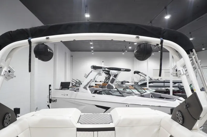 Slide: The Image of 2018 Sea Ray SLX-W 230 boat displayed in a showroom with sleek interior design. - 51
