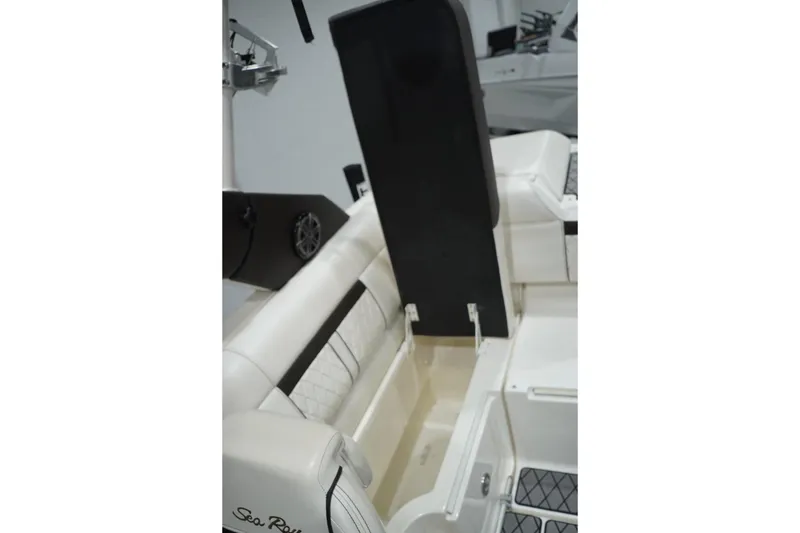 Slide: The Image of 2018 Sea Ray SLX-W 230 boat interior with open storage compartment and seating. - 54