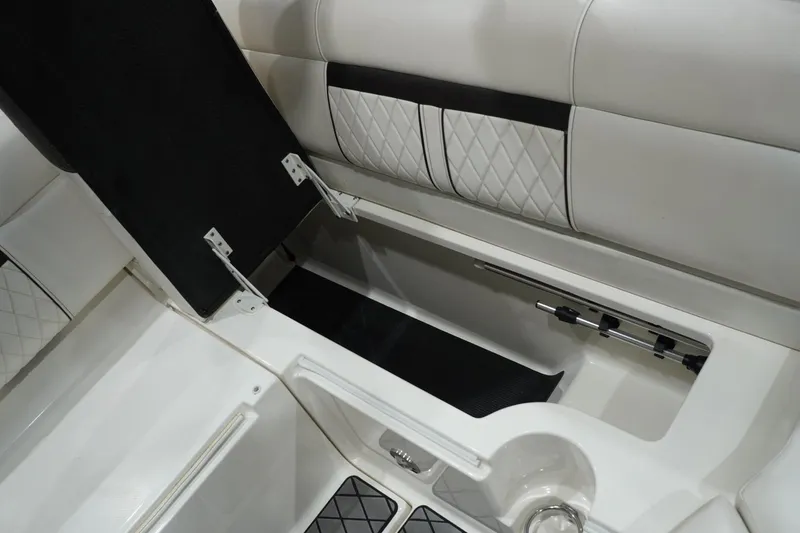 Slide: The Image of 2018 Sea Ray SLX-W 230 boat interior storage compartment with quilted upholstery. - 55