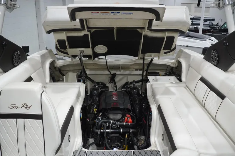 Slide: The Image of 2018 Sea Ray SLX-W 230 boat engine compartment with open hatch and seating. - 58