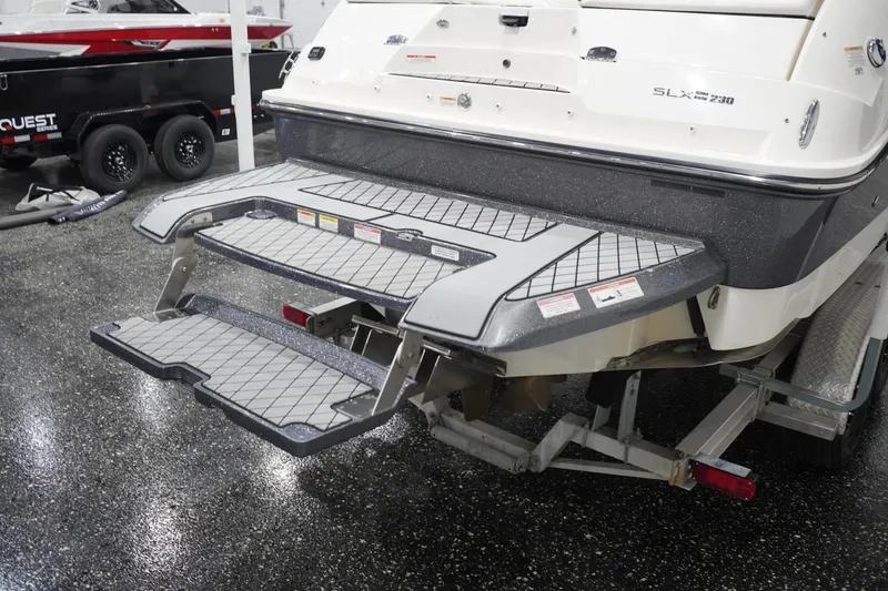 Slide: The Image of 2018 Sea Ray SLX-W 230 boat with extended swim platform in showroom. - 6