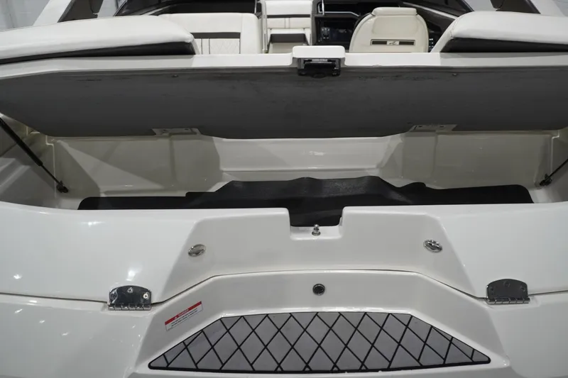Slide: The Image of 2018 Sea Ray SLX-W 230 boat interior storage compartment with open hatch. - 62