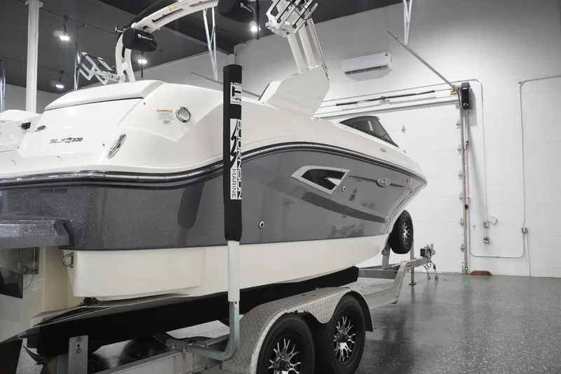 Slide: The Image of 2018 Sea Ray SLX-W 230 boat on trailer in indoor showroom. - 8