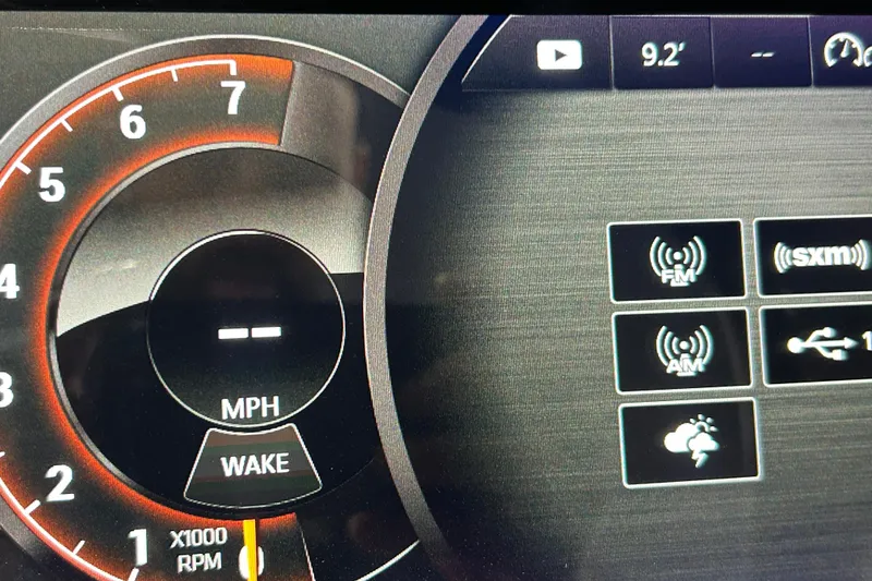 Slide: The Image of Dashboard of 2018 Sea Ray SLX-W 230 showing speedometer and media controls. - 9