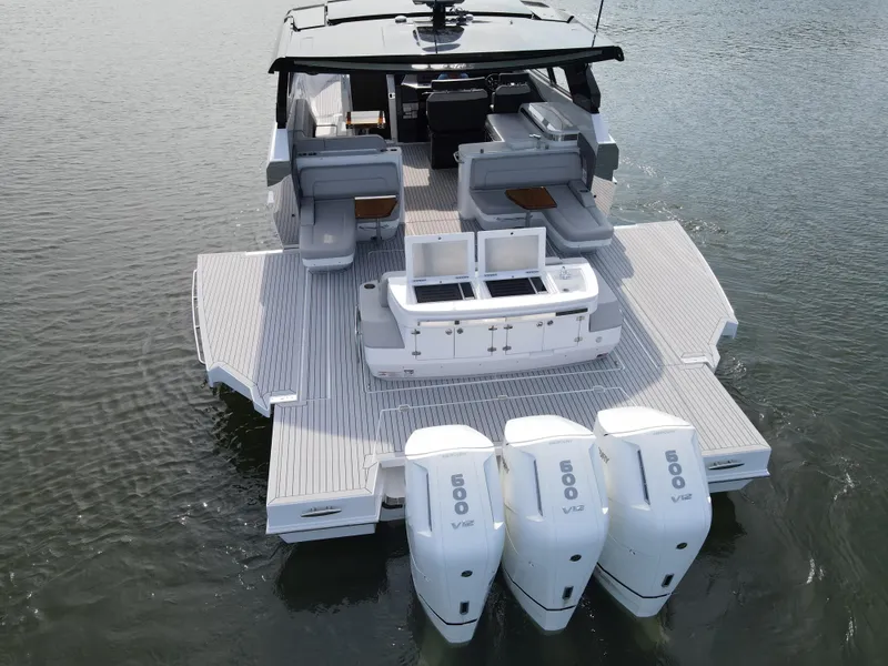 Slide: The Image of 2025 Cruisers Yachts 50 GLS Outboard with triple engines on water. - 10