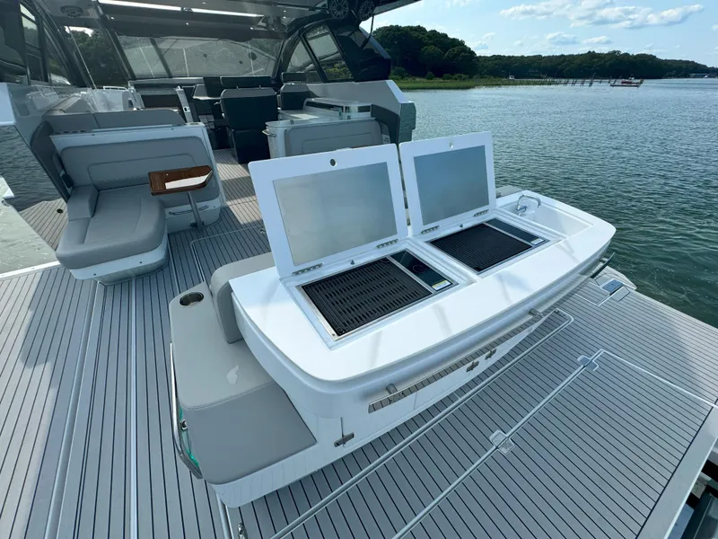 Slide: The Image of 2025 Cruisers Yachts 50 GLS Outboard luxury deck with seating and storage. - 16