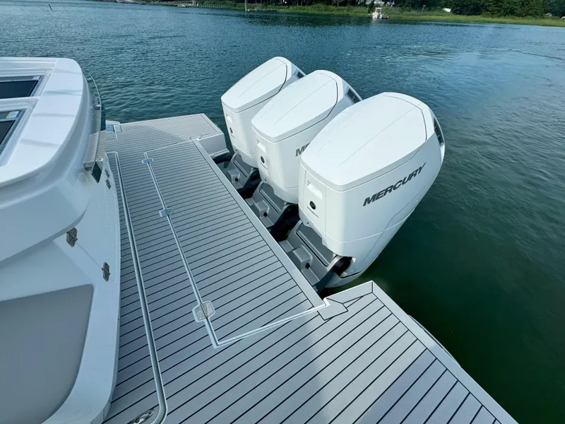 Slide: The Image of 2025 Cruisers Yachts 50 GLS Outboard with triple Mercury engines on water. - 18