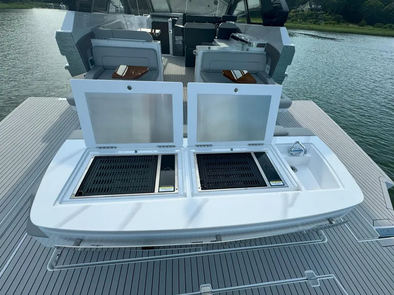 Slide: The Image of 2025 Cruisers Yachts 50 GLS Outboard deck with open storage compartments. - 19
