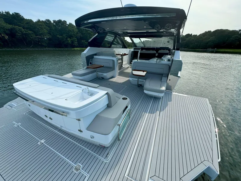 Slide: The Image of 2025 Cruisers Yachts 50 GLS Outboard luxury boat with spacious deck and seating. - 21