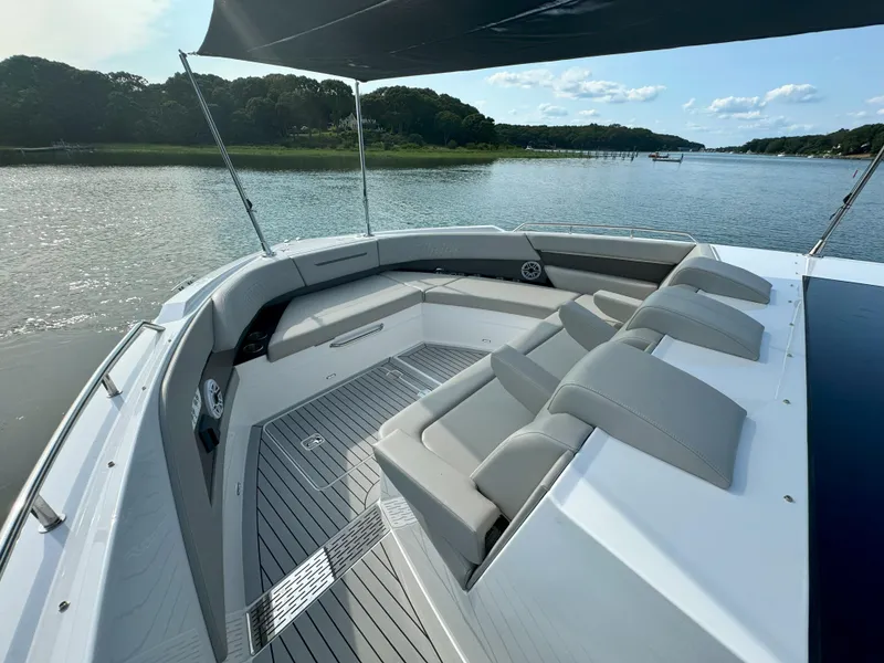 Slide: The Image of 2025 Cruisers Yachts 50 GLS Outboard, spacious deck with luxurious seating, scenic water view. - 25
