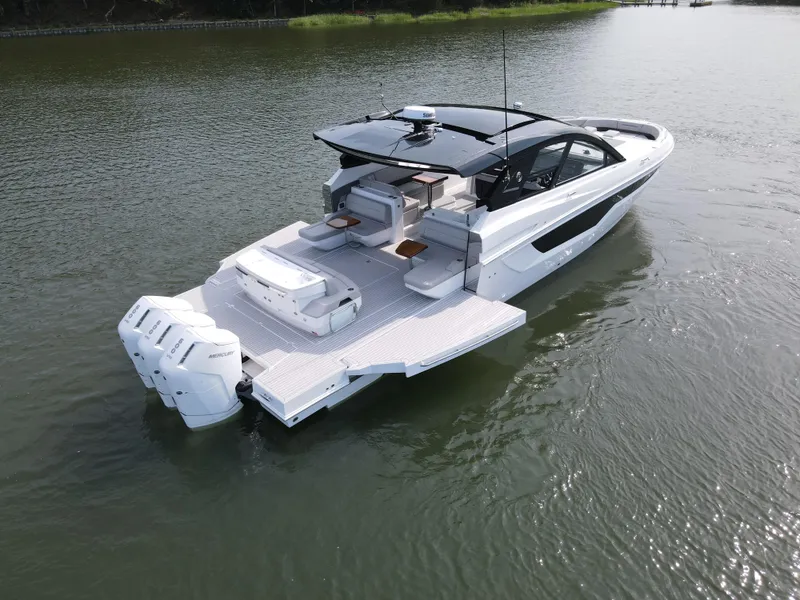 Slide: The Image of 2025 Cruisers Yachts 50 GLS Outboard on calm water. - 3