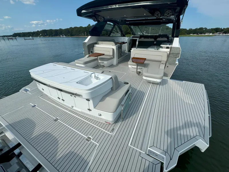 Slide: The Image of Luxurious 2025 Cruisers Yachts 50 GLS deck on calm waters. - 38