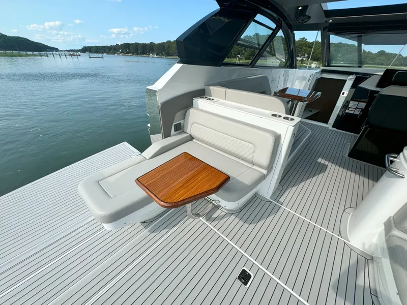 Slide: The Image of Luxurious deck of 2025 Cruisers Yachts 50 GLS with lounge and wooden table. - 40