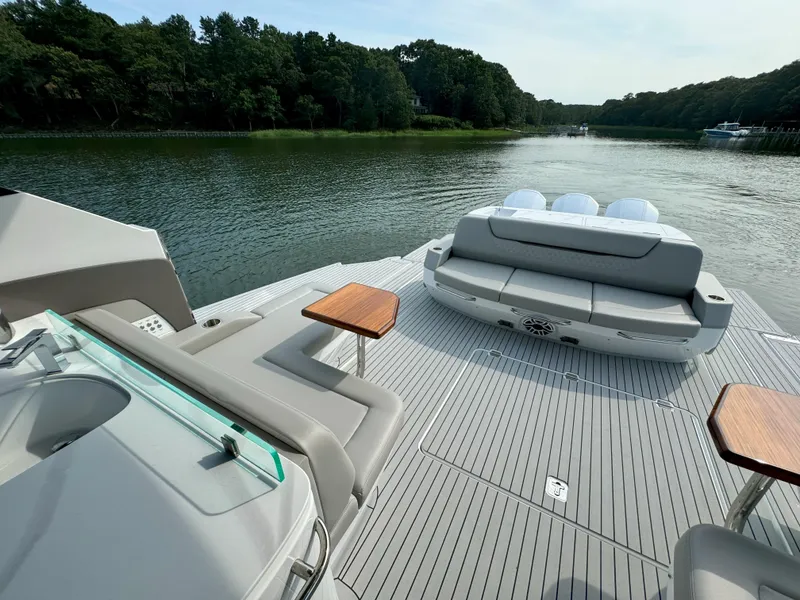 Slide: The Image of Luxurious Cruisers Yachts 50 GLS deck on serene waters. - 43