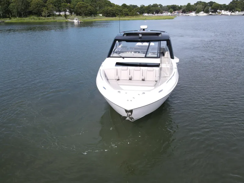 Slide: The Image of 2025 Cruisers Yachts 50 GLS Outboard on calm water. - 8