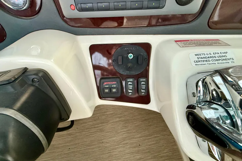 Slide: The Image of Control panel of a 2011 Meridian 391 Sedan yacht with trim tab and spotlight controls. - 12