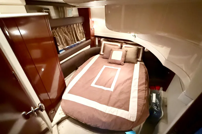 Slide: The Image of Luxurious cabin interior of 2011 Meridian 391 Sedan with cozy bed and elegant wood finishes. - 22
