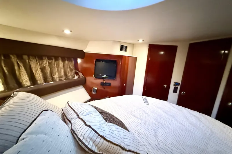 Slide: The Image of Luxurious bedroom interior of 2011 Meridian 391 Sedan yacht with cozy bedding and TV. - 26
