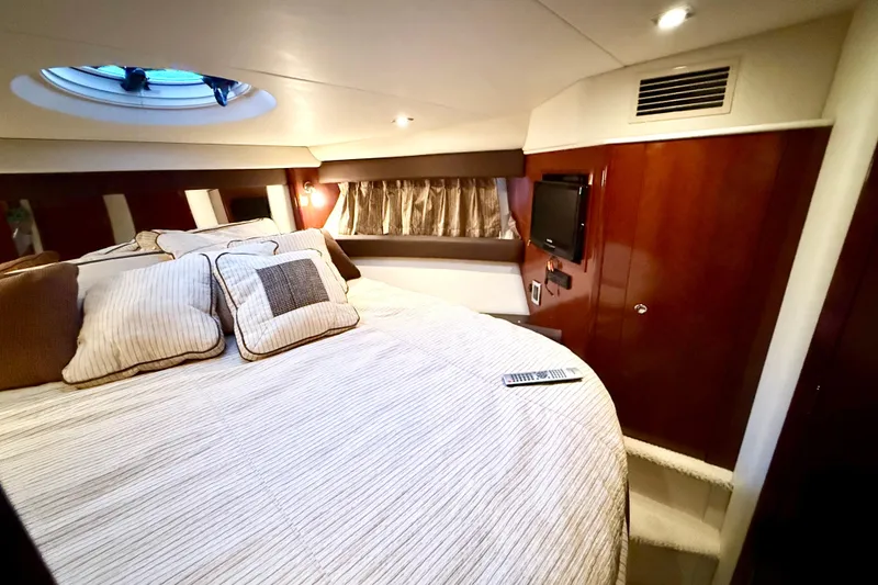 Slide: The Image of Luxurious interior of 2011 Meridian 391 Sedan yacht with cozy bedding and elegant wood finishes. - 28