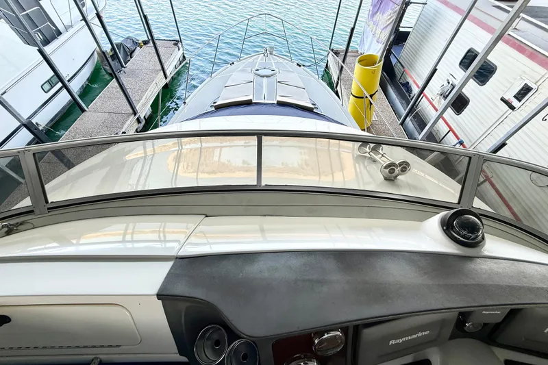 Slide: The Image of 2011 Meridian 391 Sedan yacht docked, view from helm, surrounded by water and neighboring boats. - 7